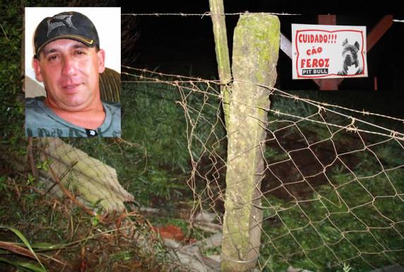 No portão que dá acesso à oficina existe uma 

placa informando da existência de cão feroz no local